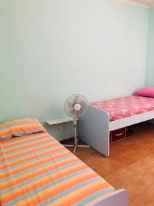 a bedroom with a bed and a fan in it at La Terrazza sul Mare in Sellia Marina