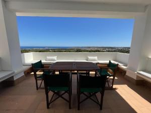 a dining room with a table and chairs and a large window at VILLASTAR by SOM Menorca in Es Mercadal