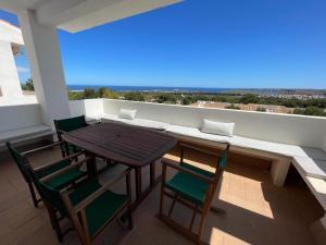 a table and chairs on a balcony with a view at VILLASTAR by SOM Menorca in Es Mercadal