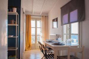 a dining room with a table and chairs and a window at Adorable Country House with sea & church view! in Kokkini Khanion