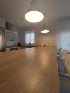 a large kitchen and living room with a large wooden table at Alojamiento La Unión in Fuengirola