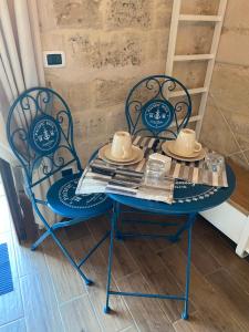 a blue table and chairs with hats on top at La Stanza in Bari