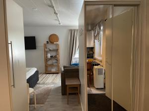 a small room with a bedroom and a living room at Little house with sauna in Lahti