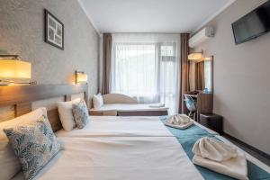 מיטה או מיטות בחדר ב-Park Hotel Asenevtsi
