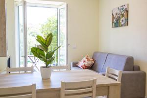 a living room with a table and a couch at Casa Corallina, wi-fi air-con IUN Q7749 in Cala Gonone