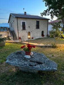a house with a light in the front of a yard at La casa di Zio Donato in Roccamorice