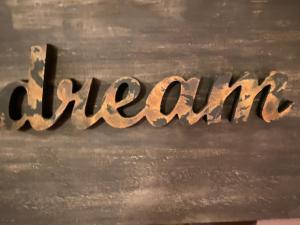 a close up of the word slavery written in rusty metal at Spa Suites at RAVEN in Hepburn Springs