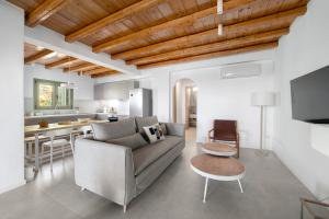 a living room with a couch and a table at Etesian Villas in Batsi