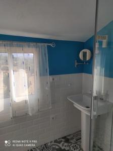 a bathroom with a shower and a sink at Agua de mayo in Hinojales