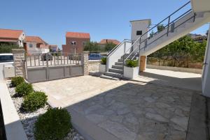 a house with a staircase and a patio at Holiday home Tcono in Tkon