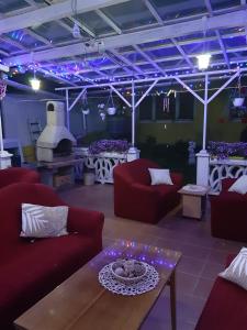 a living room with red couches and a table at Villa Vraji in Hrabušice