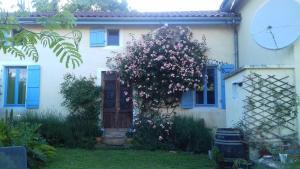 a house with a flowering tree in front of it at TheBees 