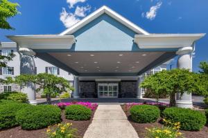 a home with a blue and white building at Comfort Inn & Suites East Greenbush - Albany in East Greenbush