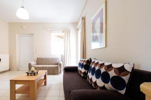 a living room with a couch and a table at Paralia Vergas Apartments in Verga Kalamata