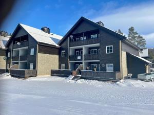 a large house in the snow in front at Experience Tranquility - Your Ideal Apartment Retreat in Uvdal, at the Base of Hardangervidda in Uvdal