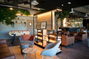 a room with couches and a pool table at Campanile Saint Brieuc - Centre Gare in Saint-Brieuc