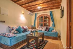 a living room with a blue couch and a table at villa Rita chaouen in Chefchaouen