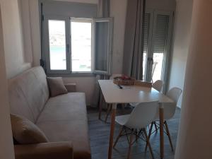 a living room with a couch and a table at LAREROOMS 2 in Mérikhas