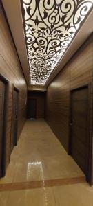 a hallway with a ceiling with a chandelier at Aquarius Touristic Resort in Al Minyah