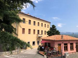 a large yellow building with a restaurant in front of it at Apartment CENTRO in Kastav