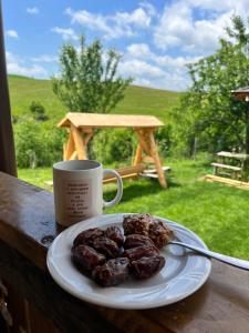 a plate of food and a cup of coffee on a table at Casa Eden Fit in Făget