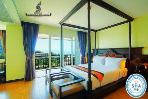 a bedroom with a canopy bed and a balcony at Royal Heritage Pavilion, Jomtien in Jomtien Beach