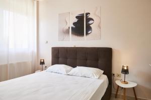 a bedroom with a large bed with white sheets at Paralia Vergas Apartments Studio in Verga Kalamata
