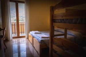 a bedroom with two bunk beds and a balcony at Agriturismo la campagnola in Gordona