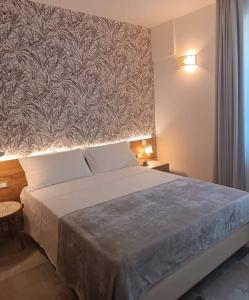 een slaapkamer met een groot bed en een grote muur bij Le stanze di Diana in Cesenatico