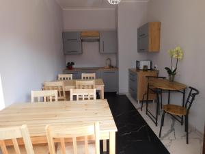 a kitchen and dining room with a wooden table and chairs at Pokoje gościnne Edan in Łeba