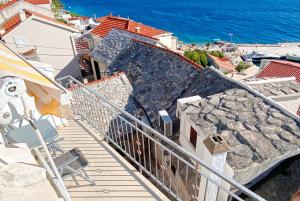 a balcony with a view of the ocean at Soline Home - holiday house - self check-in in Brela