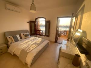 a bedroom with a bed and a view of the water at Sabina 2br penthouse in Hurghada +23 photos
