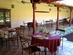 a group of tables and chairs in a restaurant at Hotel Patio del Malinche in Granada