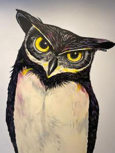 a painting of a black and white owl with yellow eyes at PAREA Athens in Athens