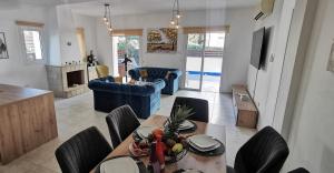 a kitchen and living room with a table and chairs at GREAT VILLA MARIA in Paralimni