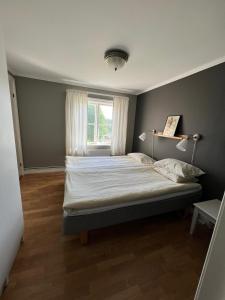 een slaapkamer met een groot bed en een raam bij Nyhyttans Kurort in Nora