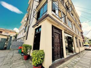 a building on a street with plants in front of it at Sabila Boutique Hotel in Kathmandu