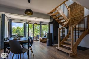 a dining room with a table and chairs and a staircase at Przystanek Gorce in Nowy Targ