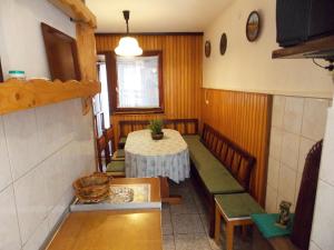 a small dining room with a table and chairs at Apartments Miro Kornić in Kornić