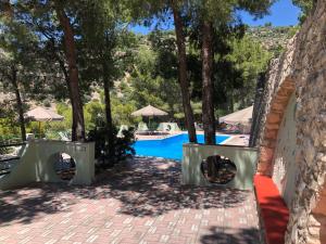a resort with a swimming pool and trees at Villa Marhù in Mattinata