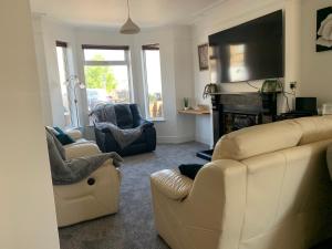 a living room with a couch and a fireplace at Inviting 3-Bed House in Lowestoft near the beach in Lowestoft