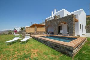 a villa with a swimming pool in a yard at Etesian Villas in Batsi