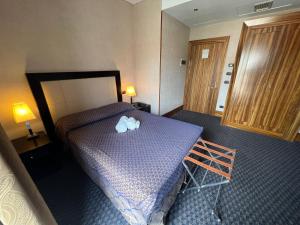 Postel nebo postele na pokoji v ubytování Hotel La Fenice