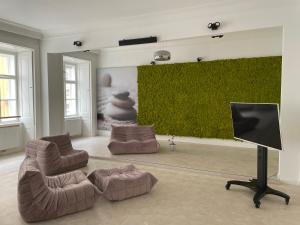 a living room with two couches and a flat screen tv at Luxury City Apartment Downtown Vienna in Vienna