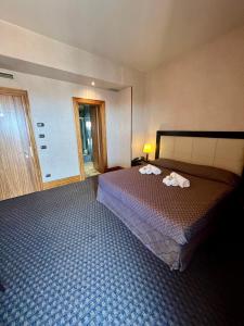 Postel nebo postele na pokoji v ubytování Hotel La Fenice