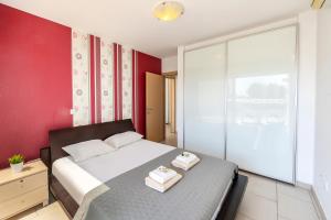 a bedroom with a bed with two towels on it at Fig Tree bay Apartment 103 in Protaras
