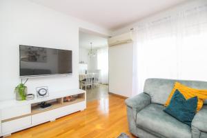 sala de estar con sofá y TV en Apartments Lotta, en Zadar