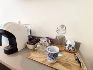 a cutting board with a coffee maker and a cup on a counter at Le stanze di Diana in Cesenatico +7 photos