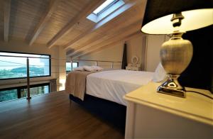 a bedroom with a bed and a lamp on a table at Moonlight Suites in Parga