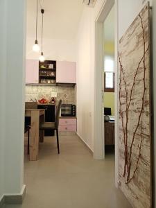 a kitchen with a table and a dining room at Marw's home in Nafplio